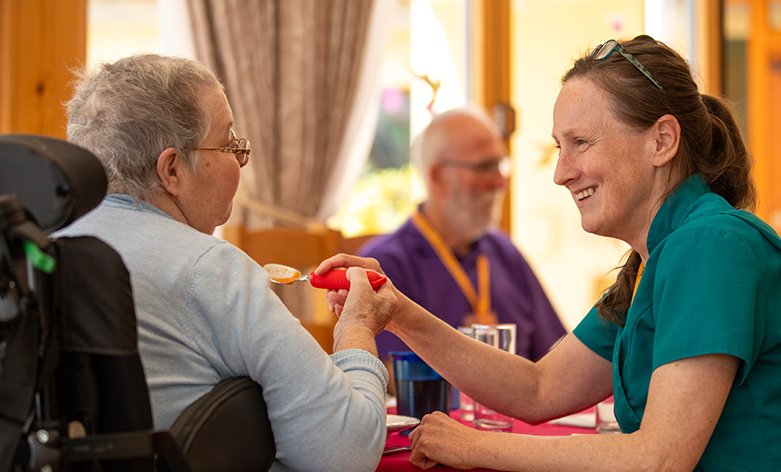 Photo of nurse helping nurse resident