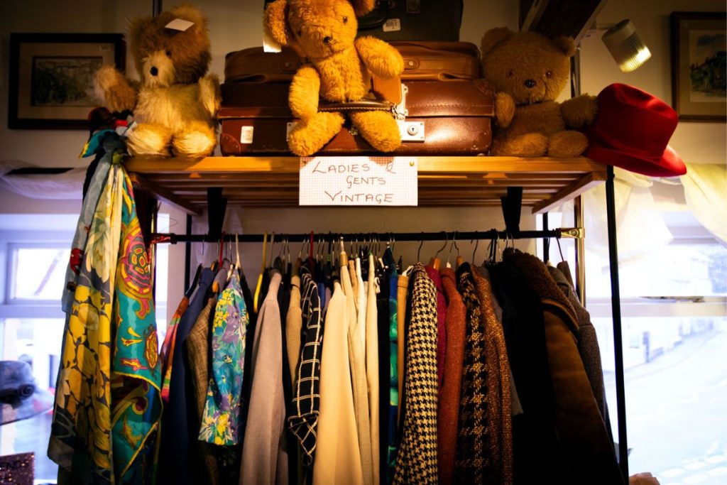 The Ladies & Gents Vintage clothing rack with teddies sitting above at the Skanda Vale Hospice Charity Shop.