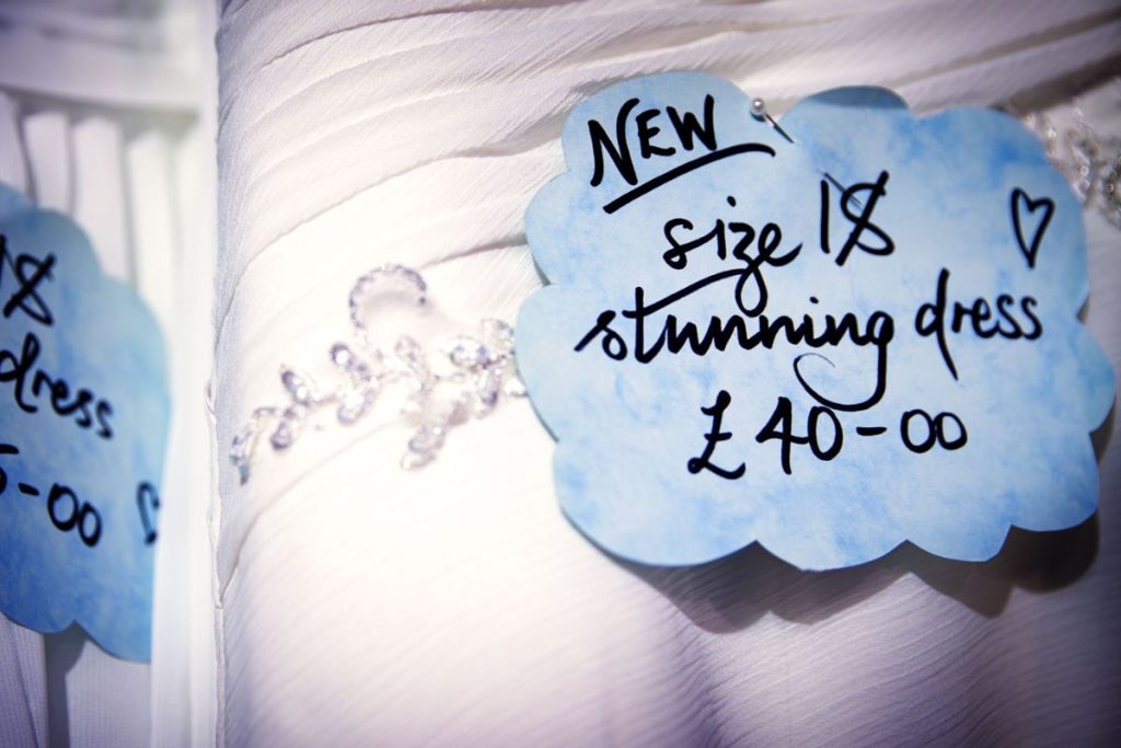 A wedding dress with a tag "New, size 18, stunning dress, £40".