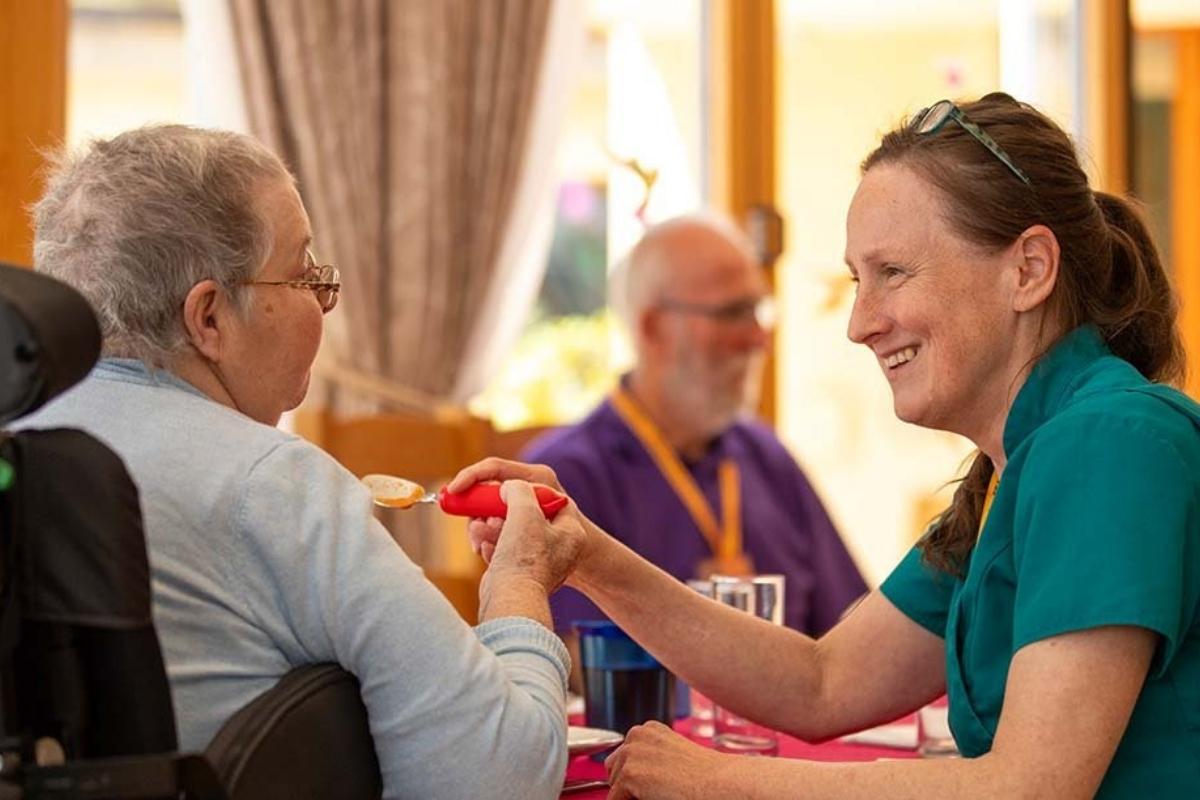 Volunteer helping patient at Skanda Vale