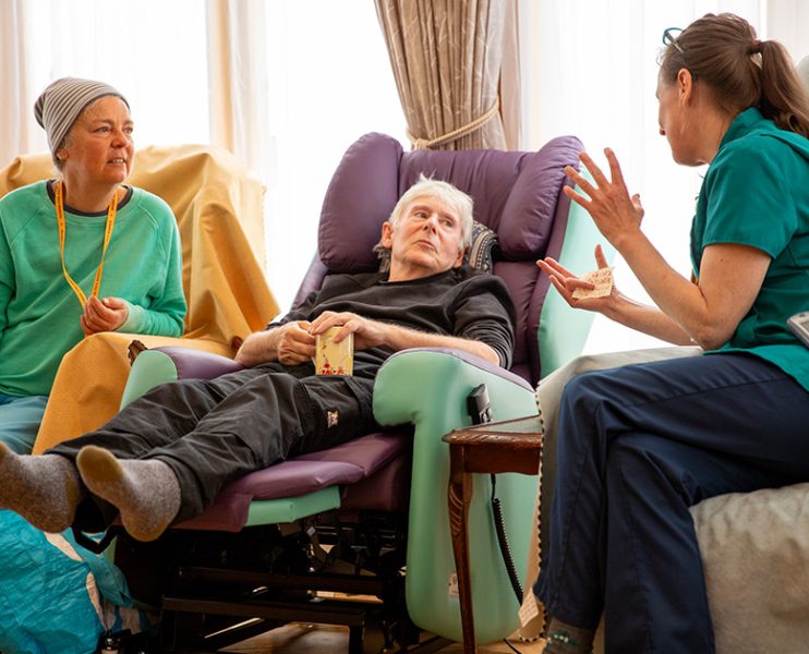 Photo two nurses with resident