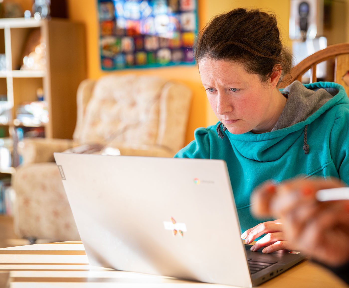 A young administrator working at a laptop in a hospice